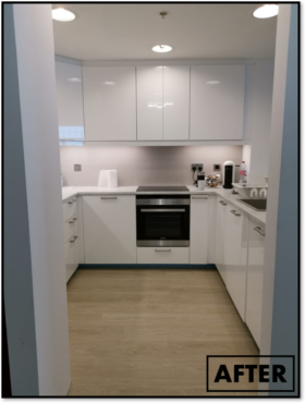 A white kitchen with a stove, microwave, and toaster oven. 